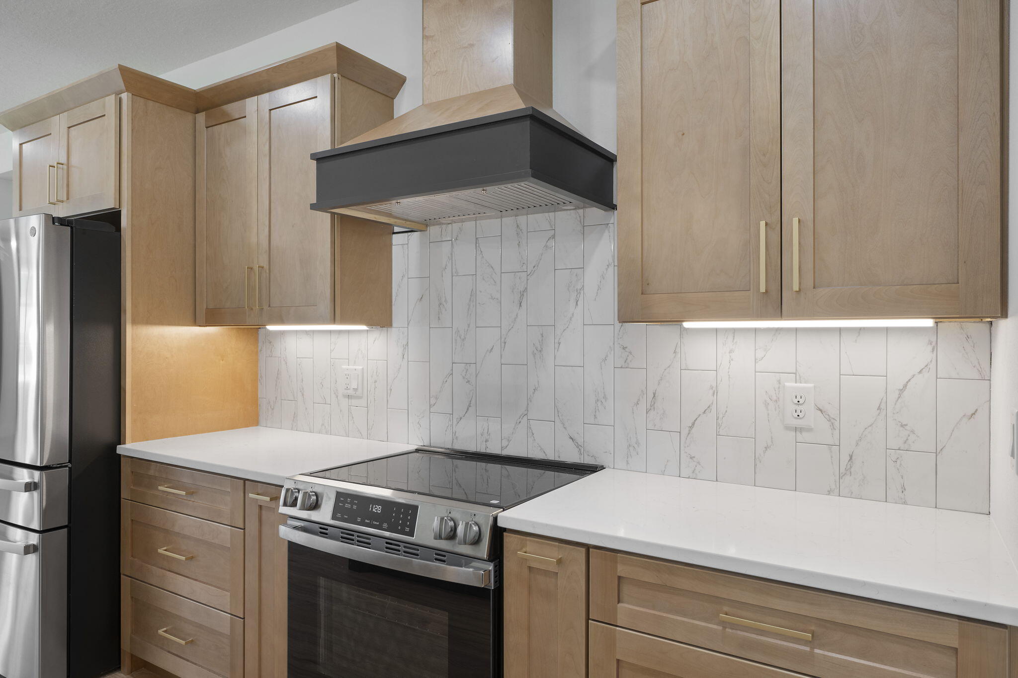 a kitchen with a stove and a refrigerator