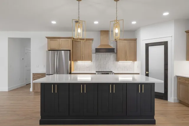 a kitchen with stainless steel appliances granite countertop a sink a window and cabinets
