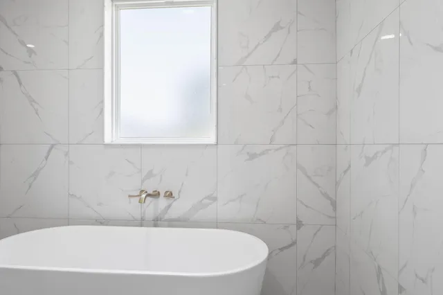 a spacious bathroom with a bathtub and shower
