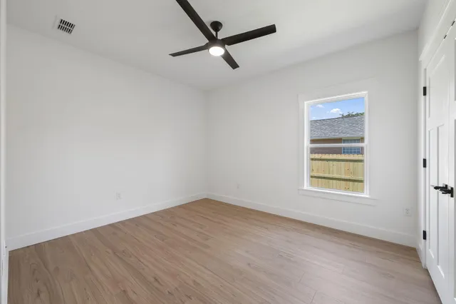a view of a room with wooden floor