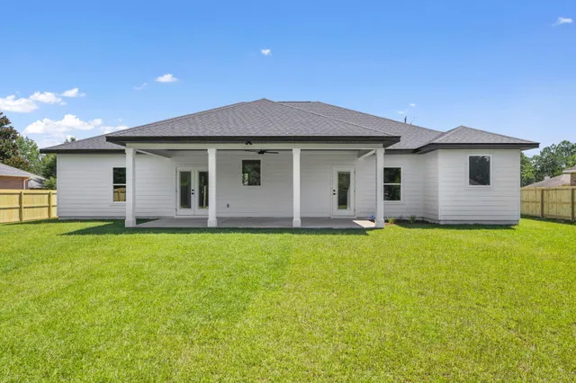 a view of a house with a backyard