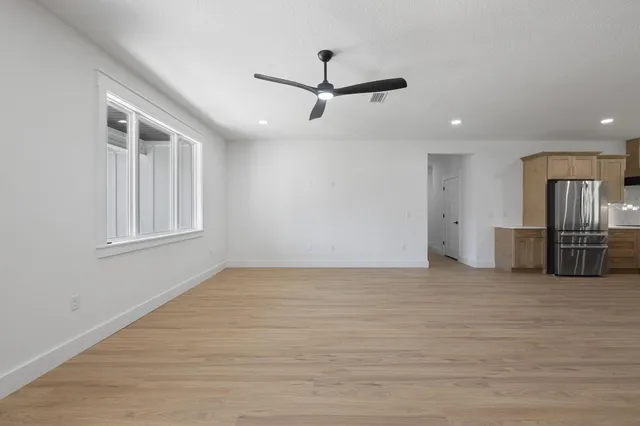 wooden floor in an empty room with a window