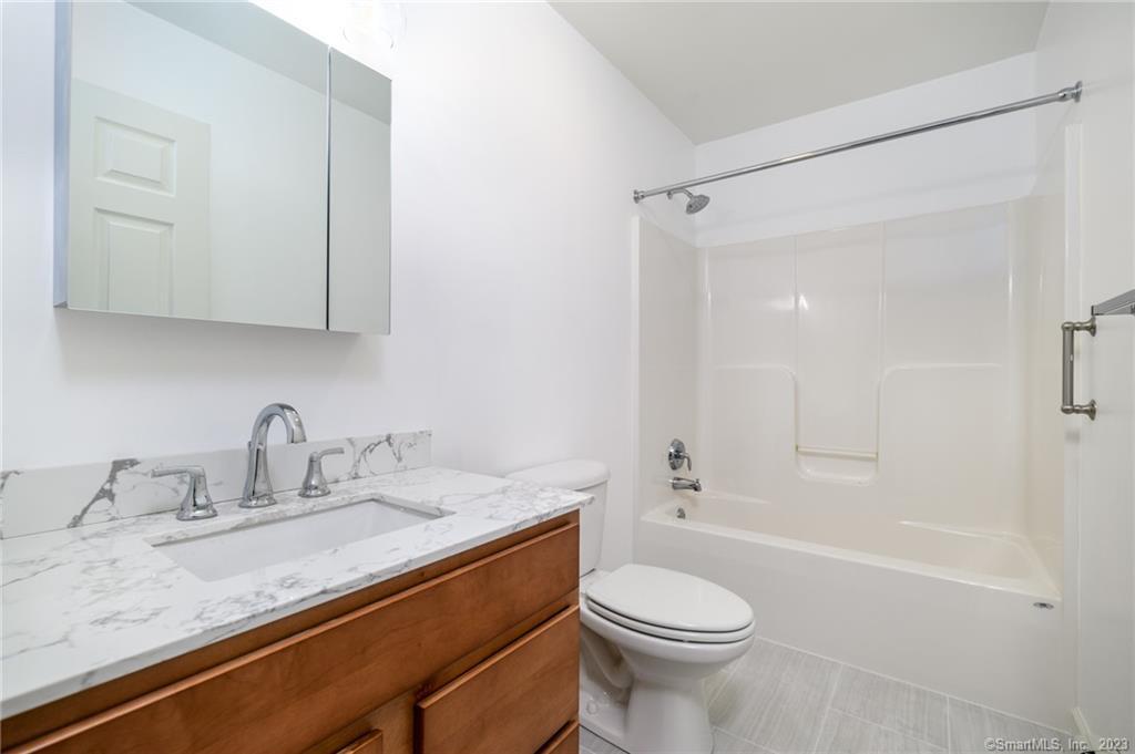 217 Highlawn Road Fairfield, CT 06824 - Photo 11 of 27 a bathroom with a granite countertop sink toilet and shower