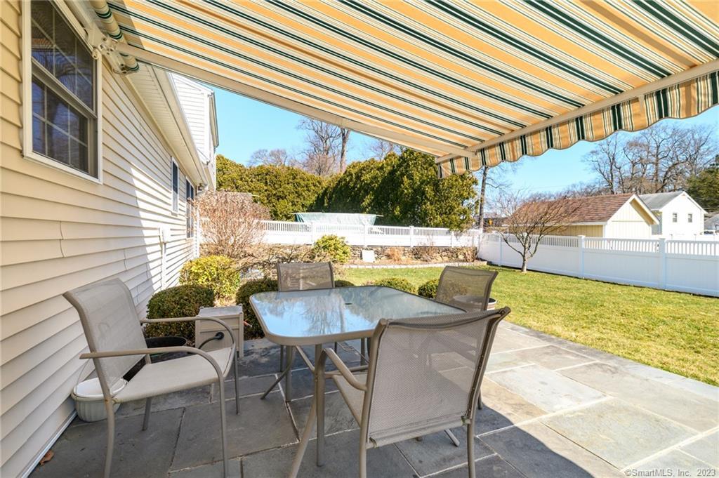 217 Highlawn Road Fairfield, CT 06824 - Photo 21 of 27 a view of a patio with table and chairs and potted plants