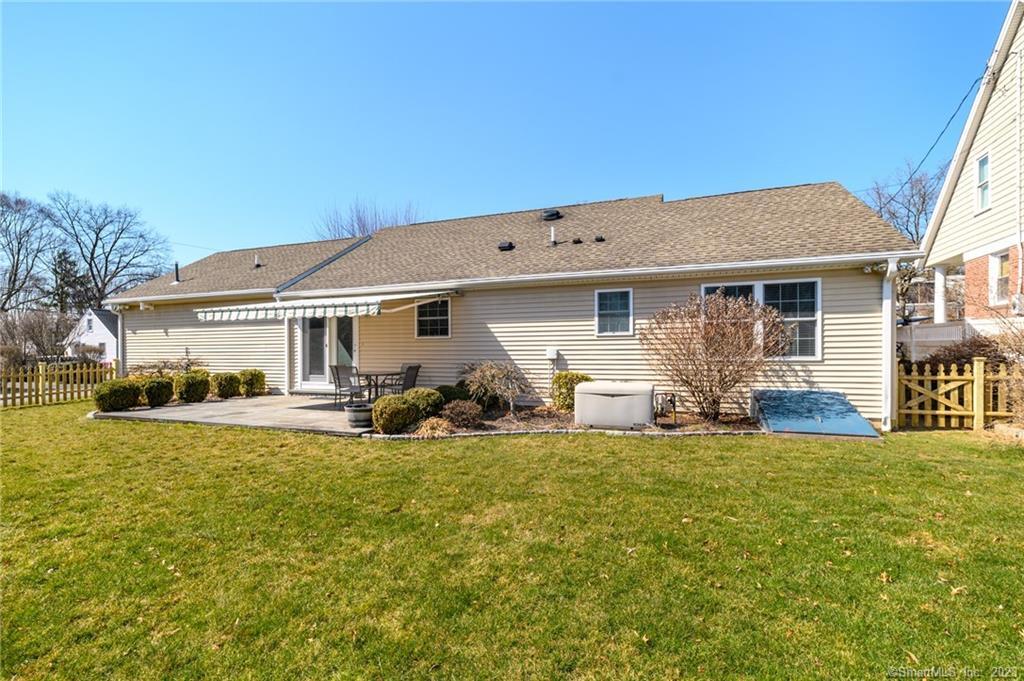 217 Highlawn Road Fairfield, CT 06824 - Photo 24 of 27 a view of a house with a yard patio and fire pit