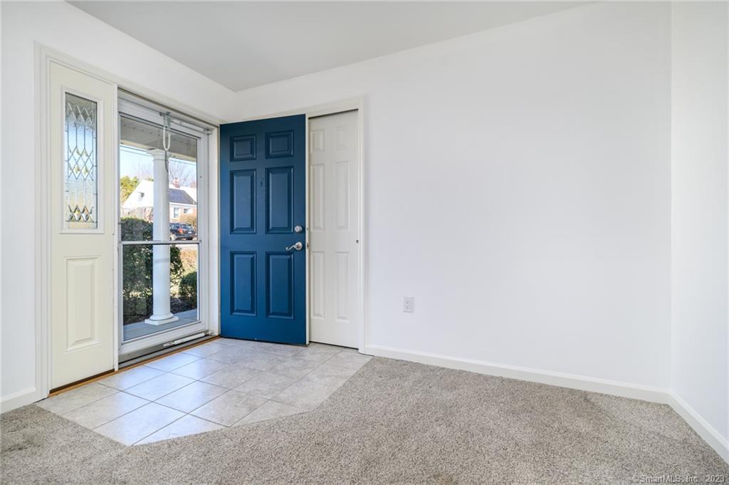 217 Highlawn Road Fairfield, CT 06824 - Photo 3 of 27 an empty room with entrance and door