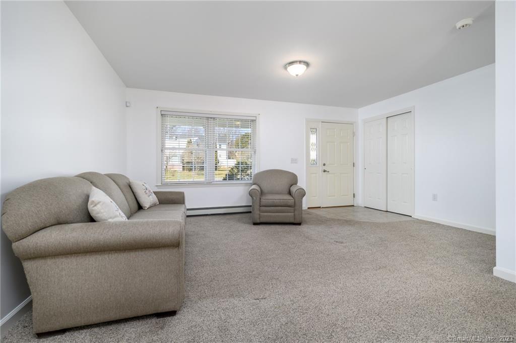 217 Highlawn Road Fairfield, CT 06824 - Photo 5 of 27 a living room with furniture and a large window