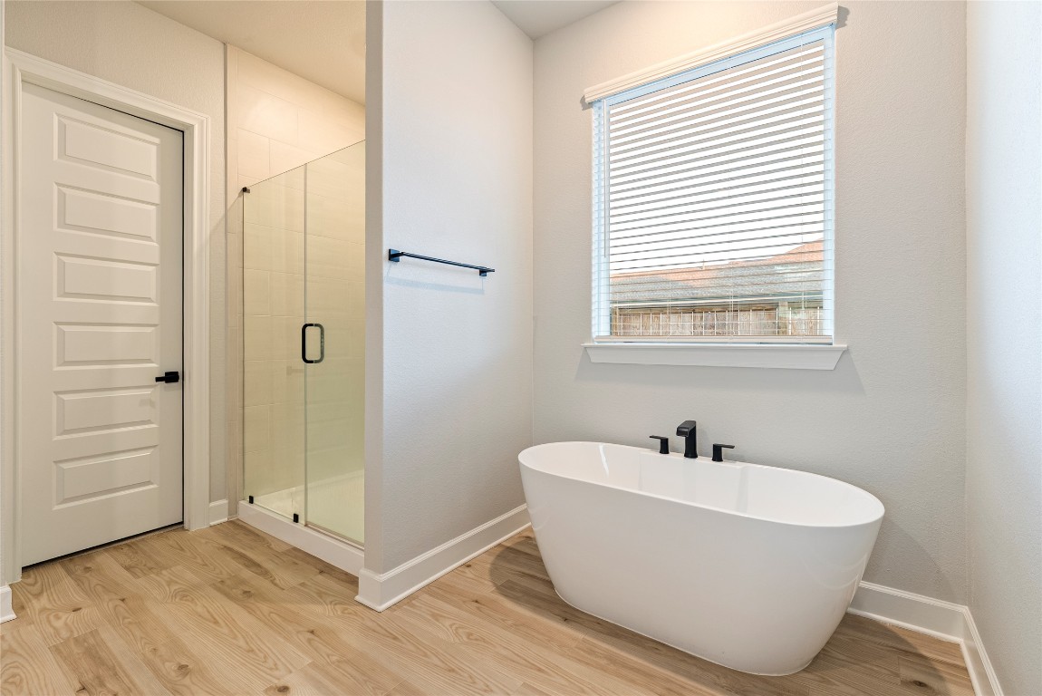 17113 Howdy Way Manor, TX 78653 - Photo 9 of 25 a white tub sitting next to a bathroom sink