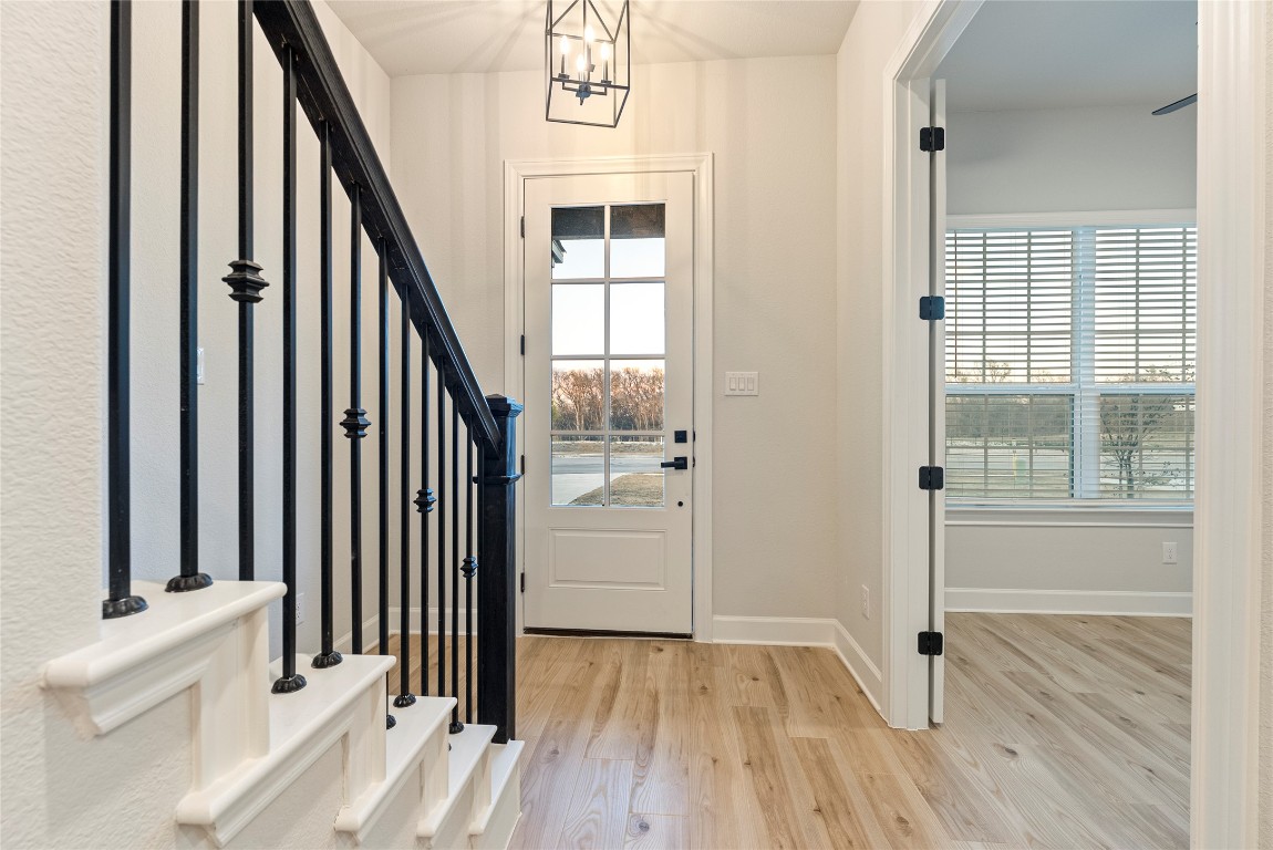 17113 Howdy Way Manor, TX 78653 - Photo 11 of 25 a view of a hallway with wooden floor and staircase