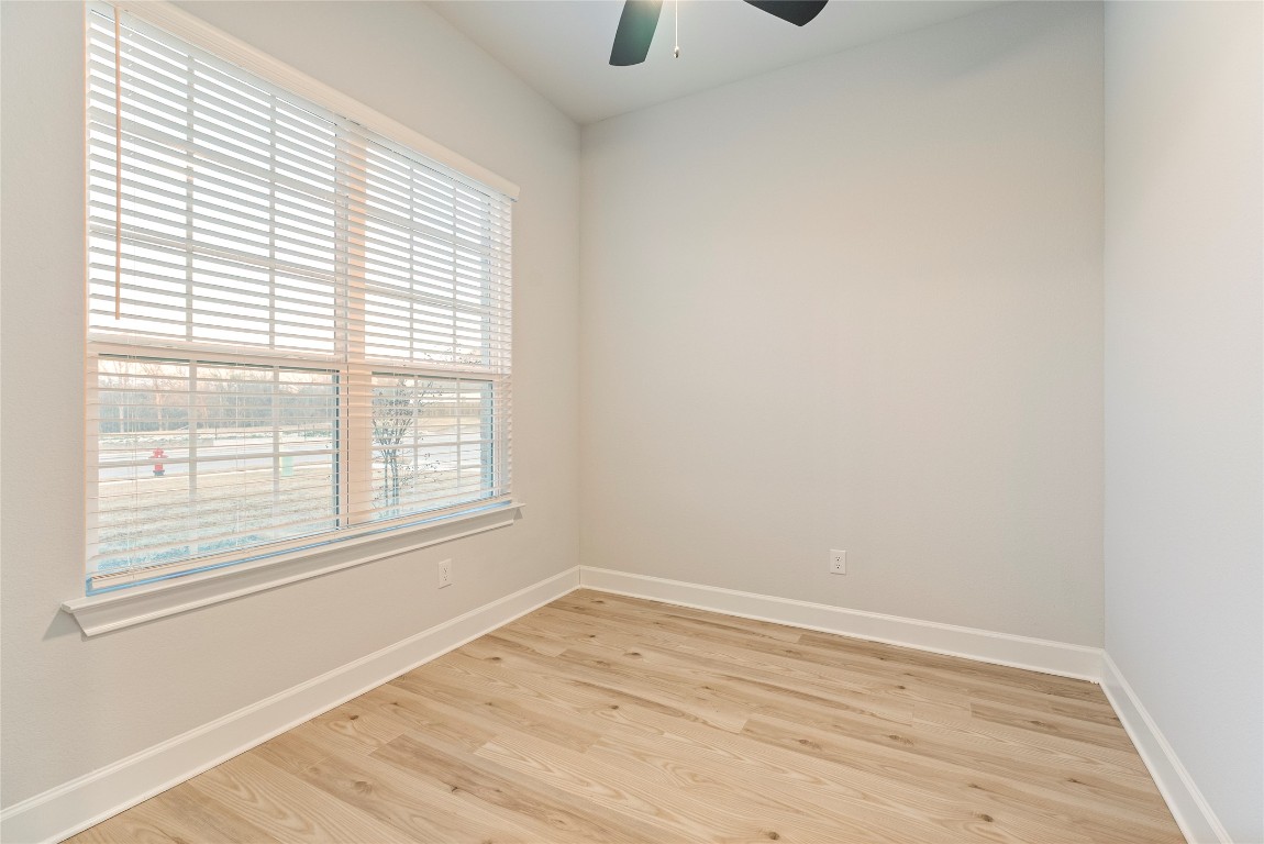 17113 Howdy Way Manor, TX 78653 - Photo 12 of 25 an empty room with wooden floor and windows