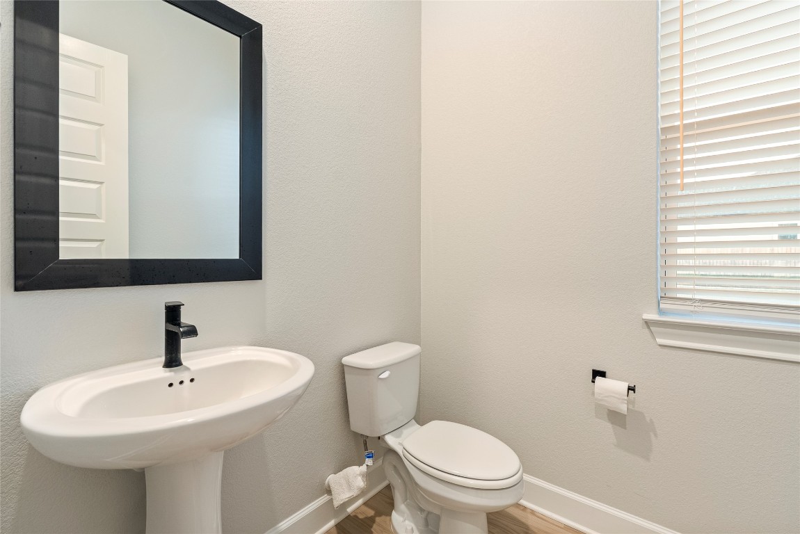 17113 Howdy Way Manor, TX 78653 - Photo 14 of 25 a bathroom with a sink a toilet and mirror
