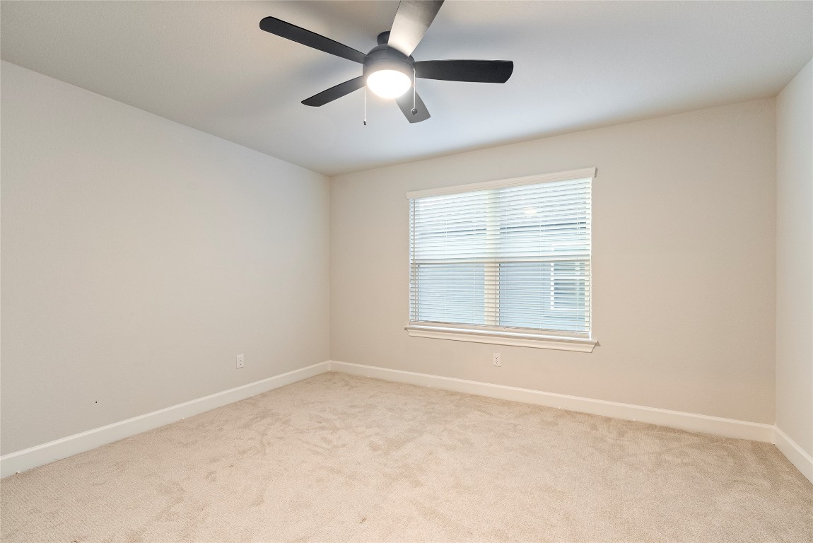 17113 Howdy Way Manor, TX 78653 - Photo 15 of 25 an empty room with a window and a fan