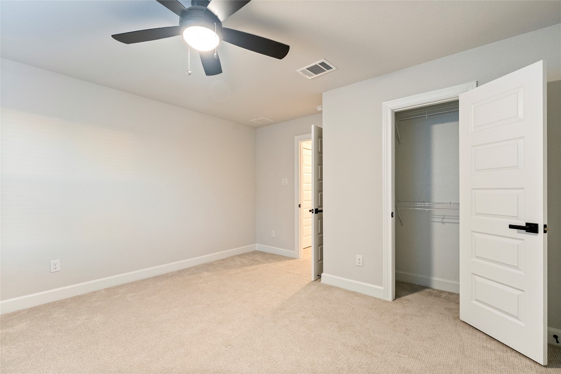 17113 Howdy Way Manor, TX 78653 - Photo 16 of 25 an empty room with chandelier fan