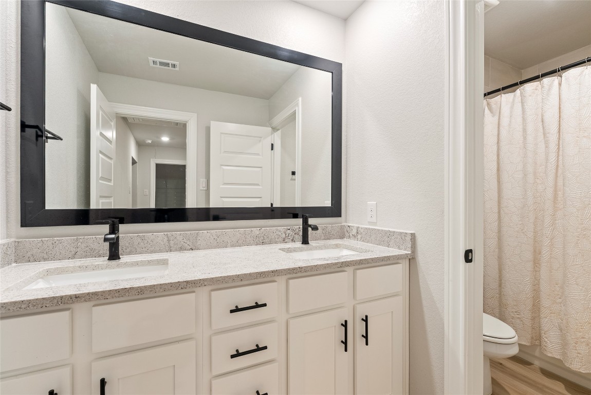 17113 Howdy Way Manor, TX 78653 - Photo 17 of 25 a bathroom with a sink and a mirror