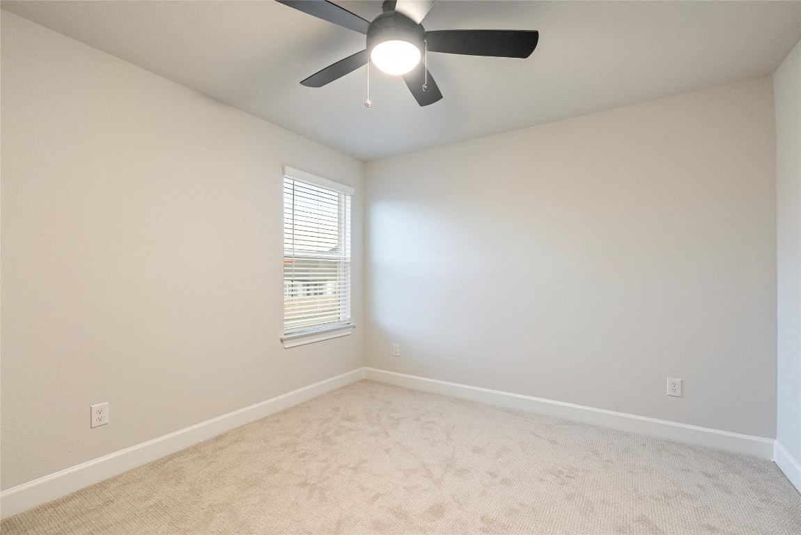 17113 Howdy Way Manor, TX 78653 - Photo 18 of 25 an empty room with a window and a fan