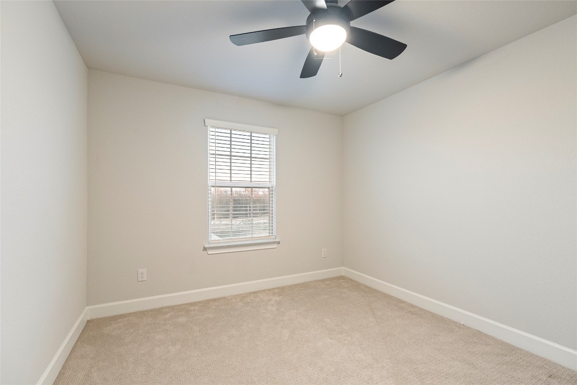 17113 Howdy Way Manor, TX 78653 - Photo 20 of 25 an empty room with a window and a fan