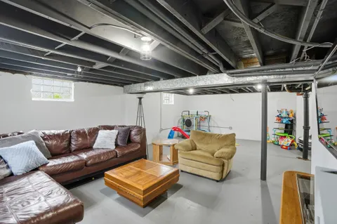 a roof deck with couch and a potted plant