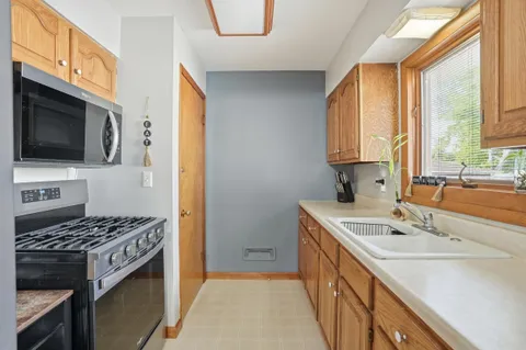 a kitchen that has a sink and a stove