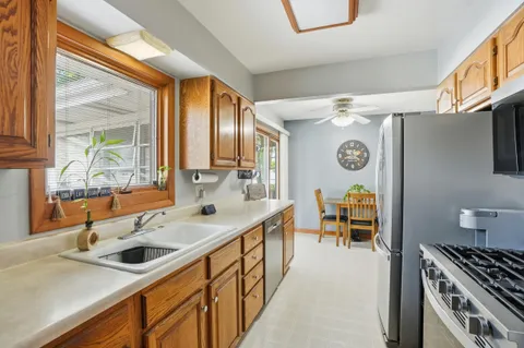 a kitchen with stainless steel appliances a sink a stove and a refrigerator