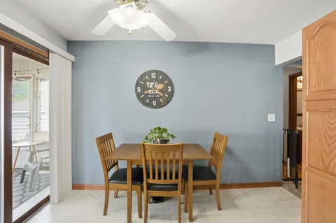 a view of a dining room with furniture and a large window