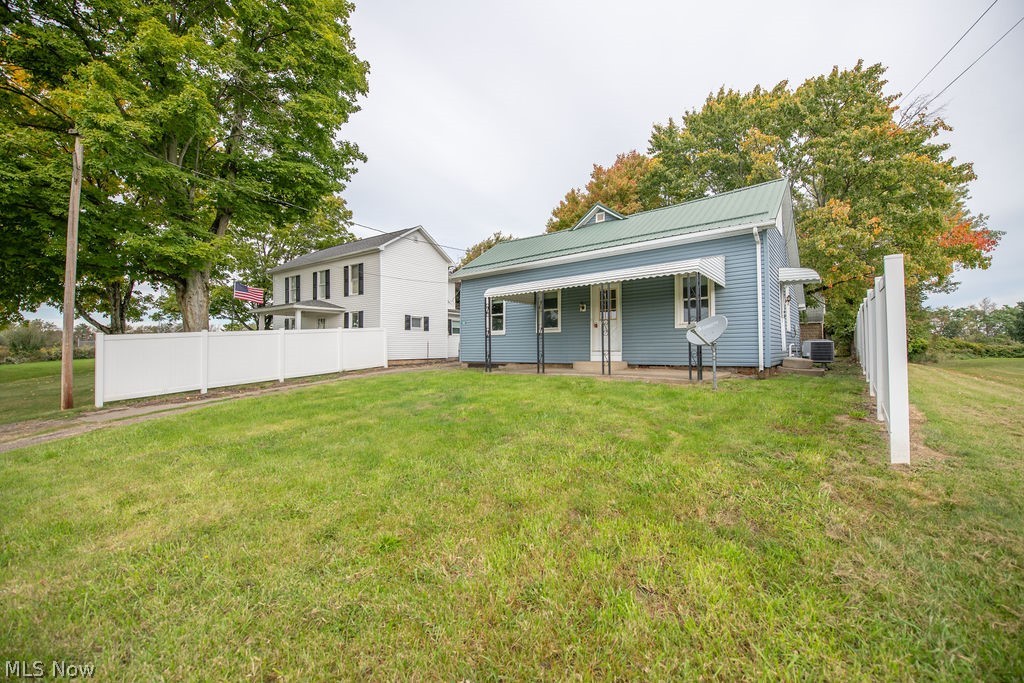 2468 Tabor Ridge Road Northeast New Philadelphia, OH 44663 - Photo 2 of 33 Exterior view of home with a metal roof featuring a covered front entrance.
