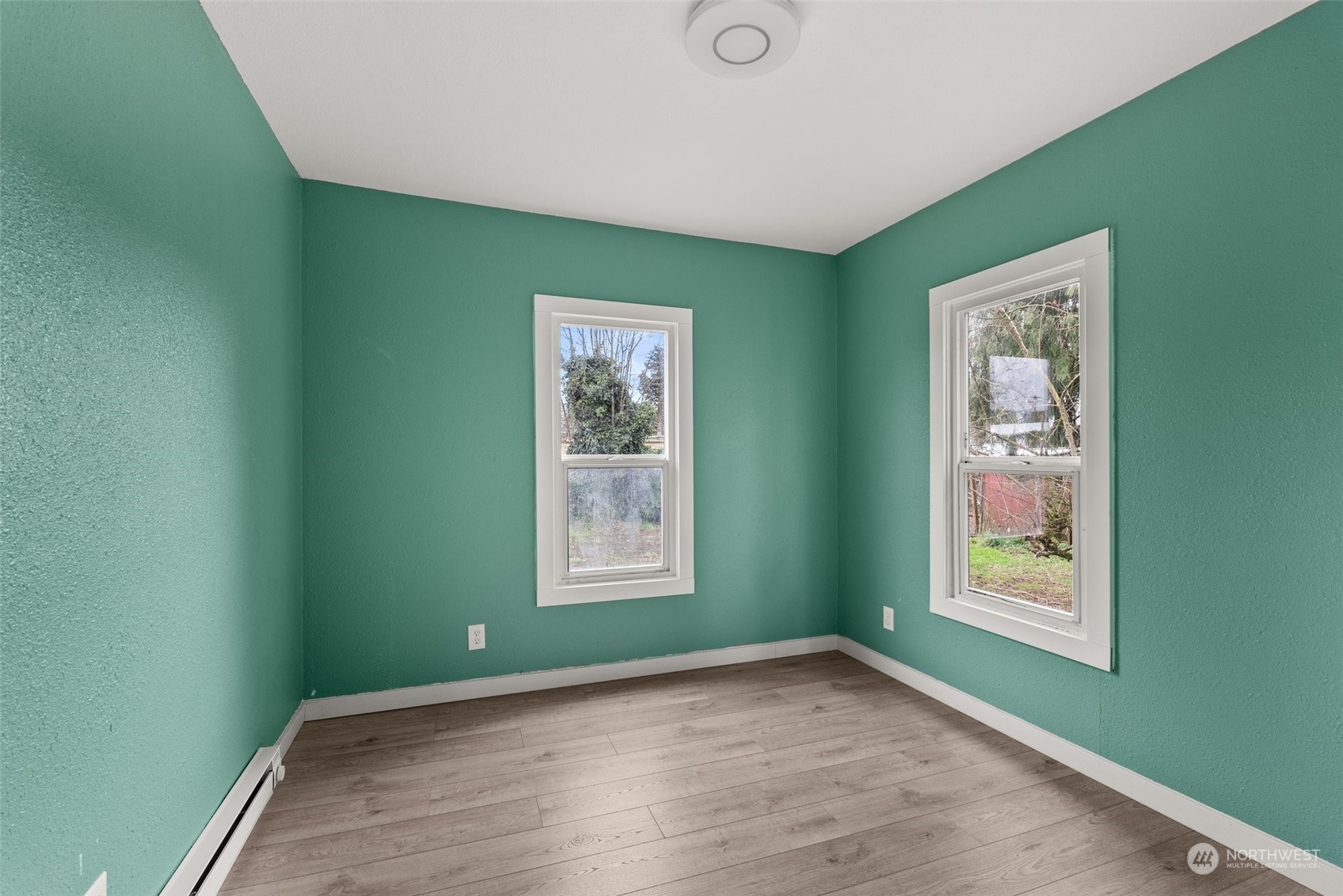 325 East Main Mossyrock, WA 98564 - Photo 13 of 24 a view of an empty room with window and wooden floor