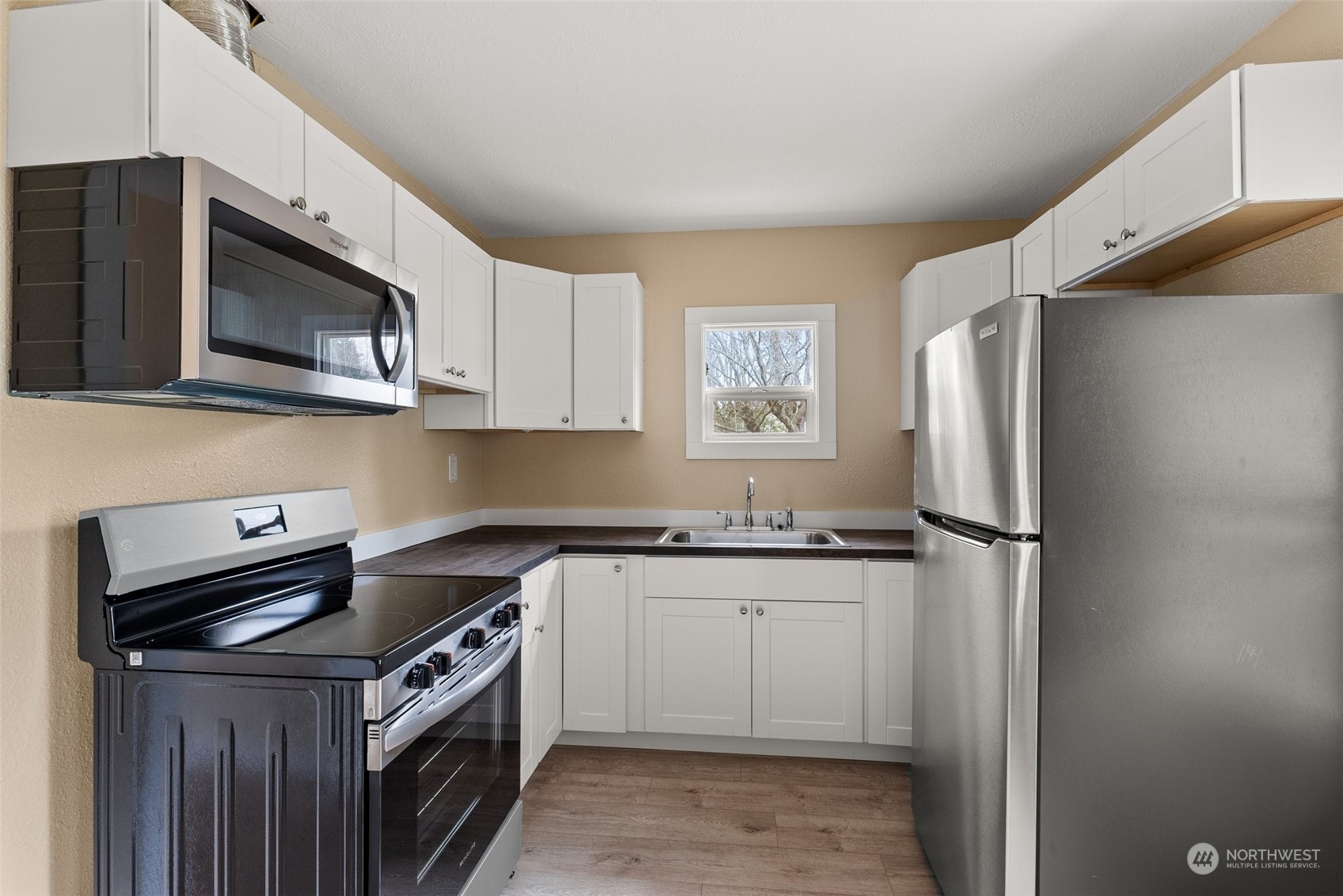 325 East Main Mossyrock, WA 98564 - Photo 3 of 24 a kitchen with stainless steel appliances granite countertop a stove a refrigerator and a microwave
