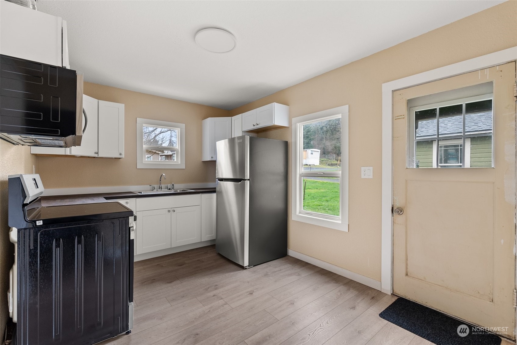 325 East Main Mossyrock, WA 98564 - Photo 4 of 24 a kitchen with a refrigerator and a stove top oven