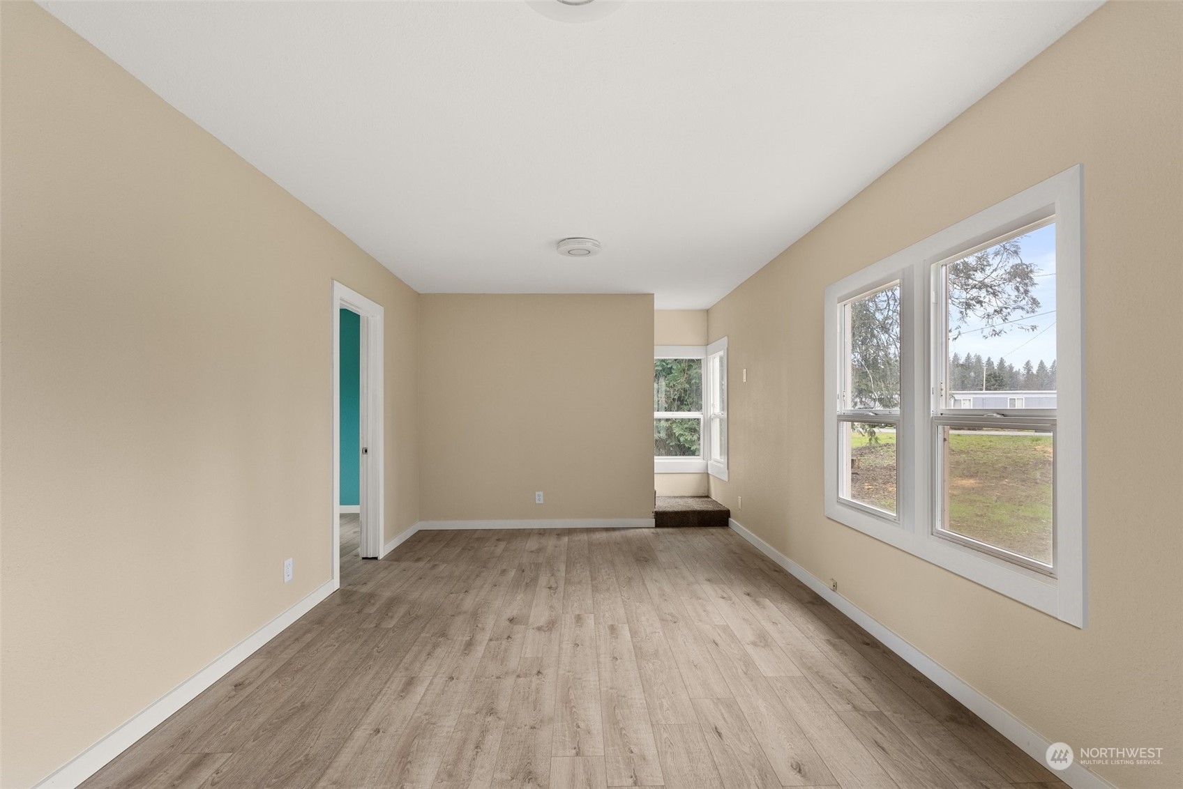 325 East Main Mossyrock, WA 98564 - Photo 6 of 24 an empty room with wooden floor and windows