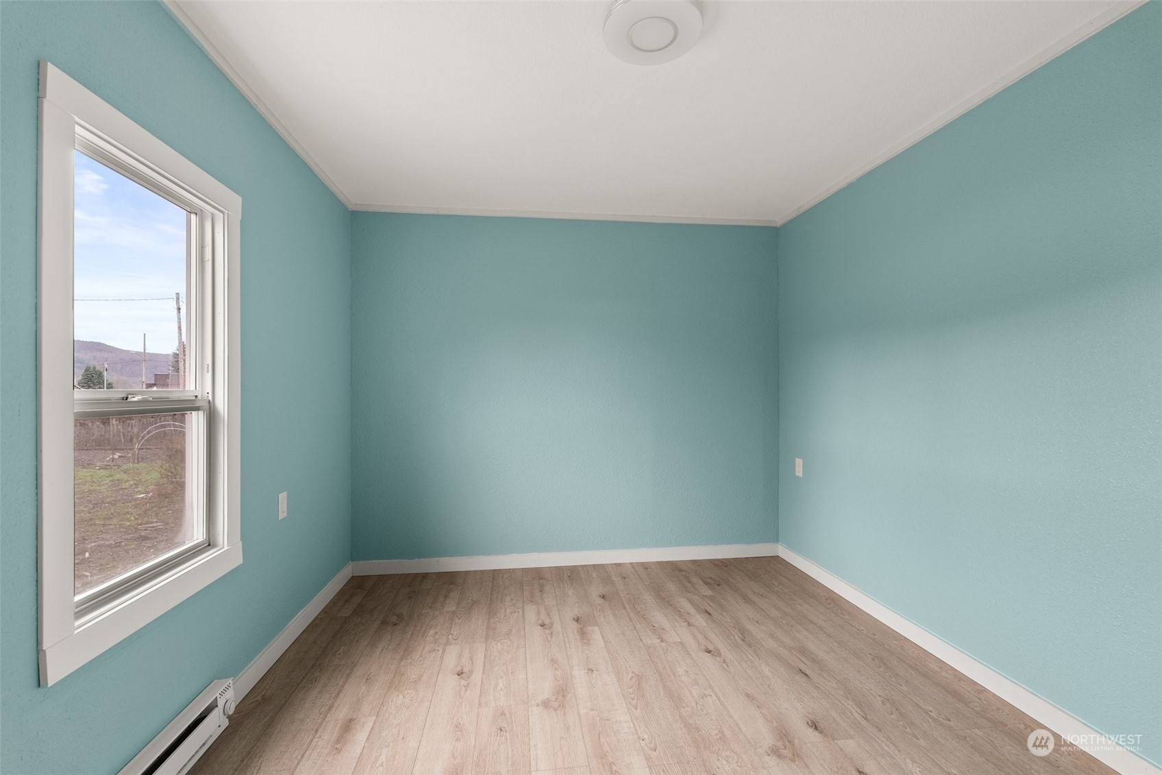 325 East Main Mossyrock, WA 98564 - Photo 8 of 24 a view of a room that has wooden floor and windows in a room