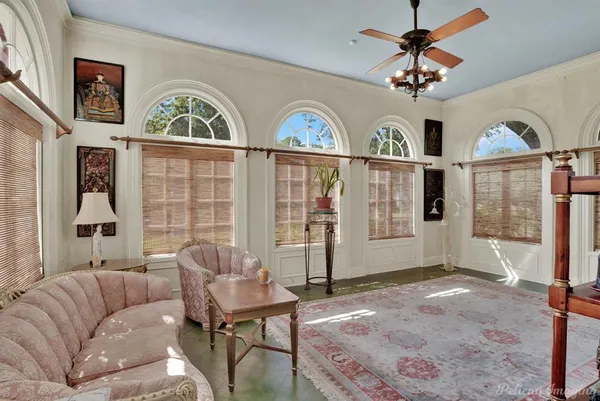 a living room with furniture windows and a flat screen tv