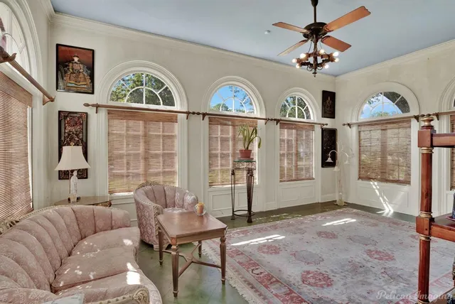 a living room with furniture windows and a flat screen tv