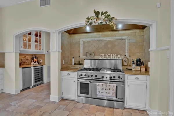 a kitchen with a stove and cabinets