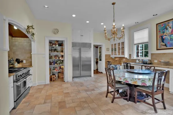 a open kitchen with stainless steel appliances granite countertop a stove and a refrigerator