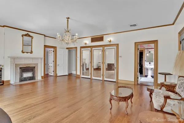 a view of a livingroom with furniture a fireplace and wooden floor