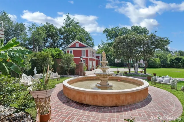 a view of a house with pool fire pit and chairs