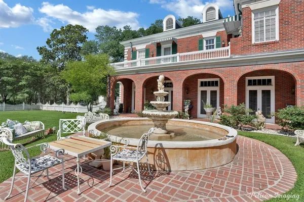 a front view of a house with garden and patio