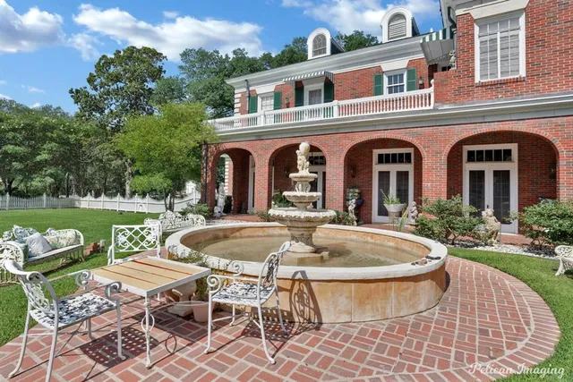 a front view of a house with garden and patio