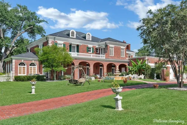 a front view of house with yard and green space