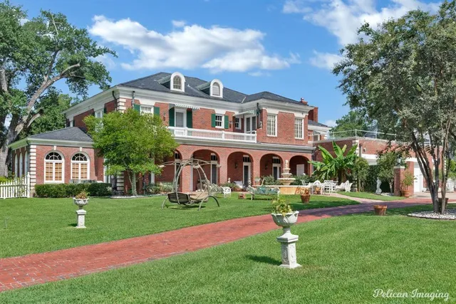 a front view of house with yard and green space