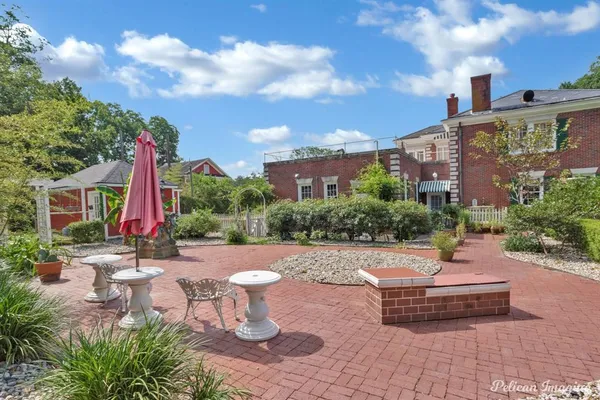 a swimming pool with outdoor seating and yard