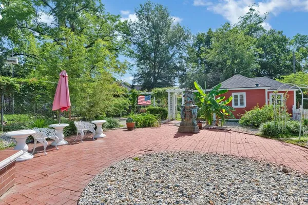 a view of a patio with a table and chairs under an umbrella