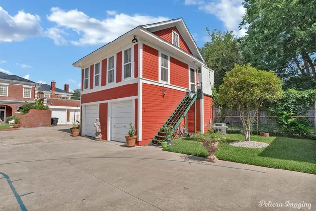 a front view of a house with a yard and trees