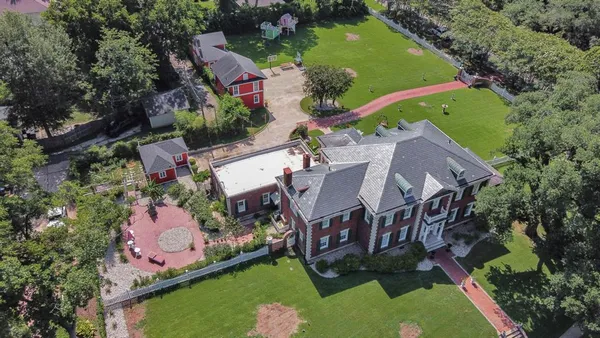 an aerial view of house with yard swimming pool and outdoor seating