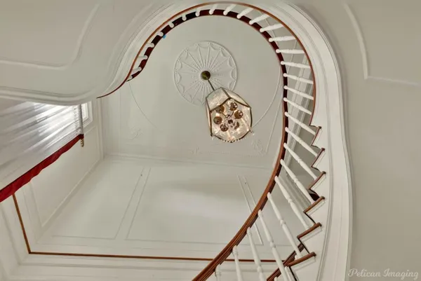 a view of staircase with white walls and a window