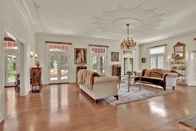 a living room with furniture and a chandelier