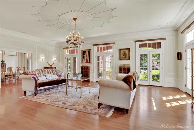 a living room with furniture or chandelier and a wooden floor