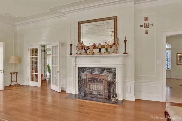 a living room with a fireplace and a wooden floor