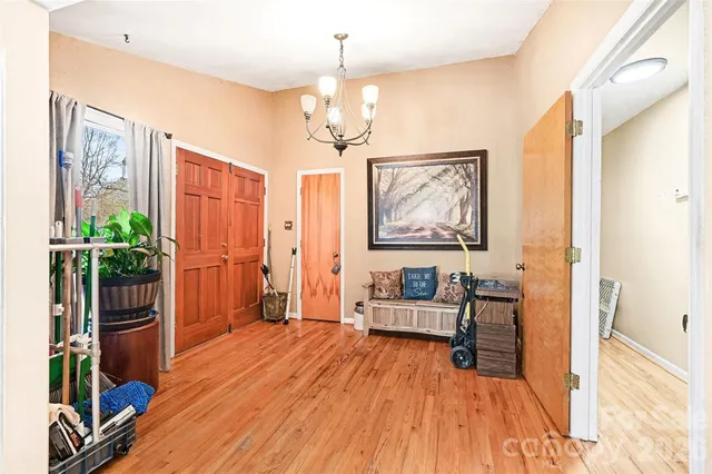 a view of a livingroom with furniture wooden floor and a chandelier