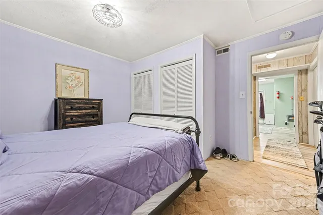 a bedroom with a bed and a dresser